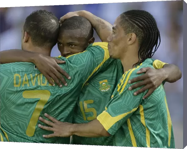South Africas Parker celebrates with teammates Davids and Pienaar after scoring against Norway during Nelson Mandela soccer challenge in Rusternburg