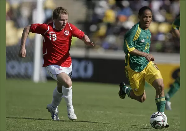South Africas Pienaar controls the ball from Norways Riise during the Nelson Mandela soccer challenge in Rusternburg