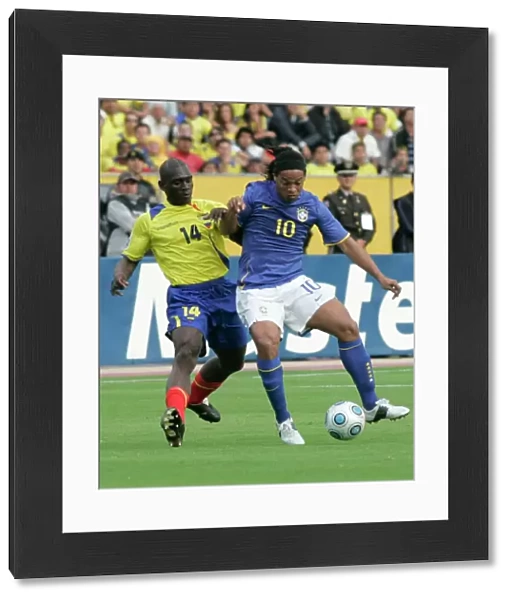Ecuadors Castillo fights for the ball Brazils Ronaldinho during their World Cup qualifier soccer match in Quito