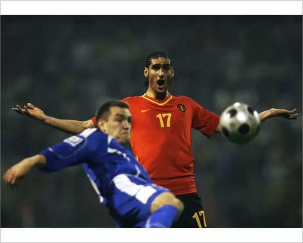 Marouane Fellaini-Bakkioui of Belgium reacts as Boris Pandza of Bosnia kicks the ball during their World Cup 2010 qualifying soccer match in Zenica