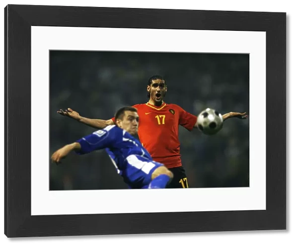 Marouane Fellaini-Bakkioui of Belgium reacts as Boris Pandza of Bosnia kicks the ball during their World Cup 2010 qualifying soccer match in Zenica