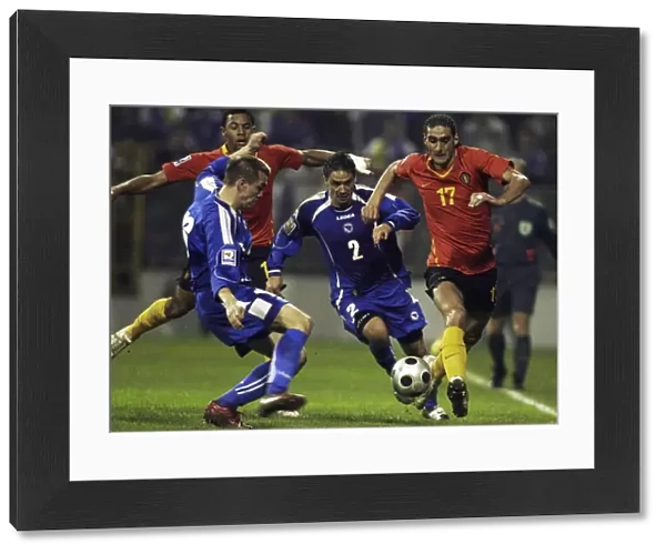 Marouane Fellaini-Bakkioui of Belgium is challanged by Bosnias Boris Pandza and Dzemal Berberovic during their 2010 World Cup qualifying soccer match in Zenica
