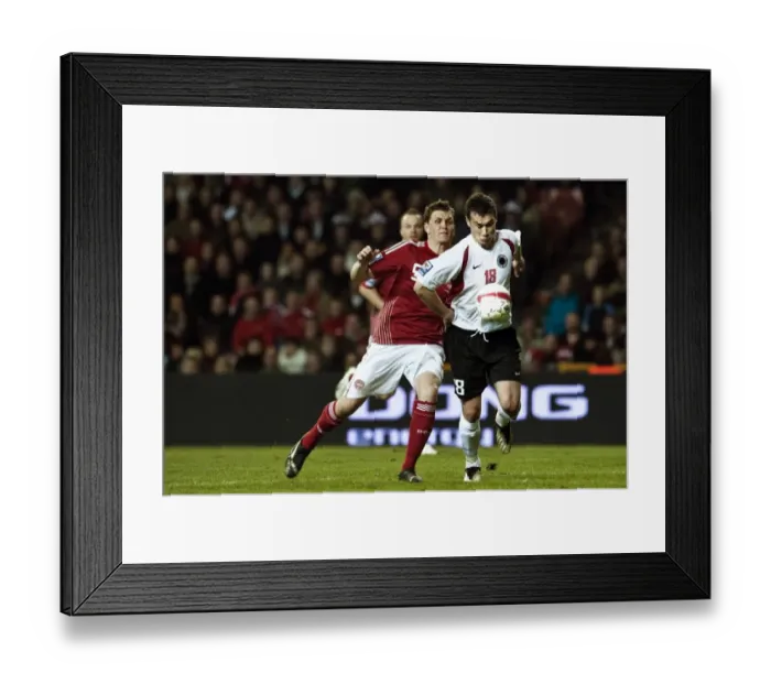 Framed Print : Denmarks Jacobsen fights for the ball with Albanias Hamdi Salihi during their 2010 World Cup qualifying soccer match in Copenhagen Framed Print : Denmarks Jacobsen fights for the ball with Albanias Hamdi Salihi during their 2010 World Cup qualifying soccer match in Copenhagen
