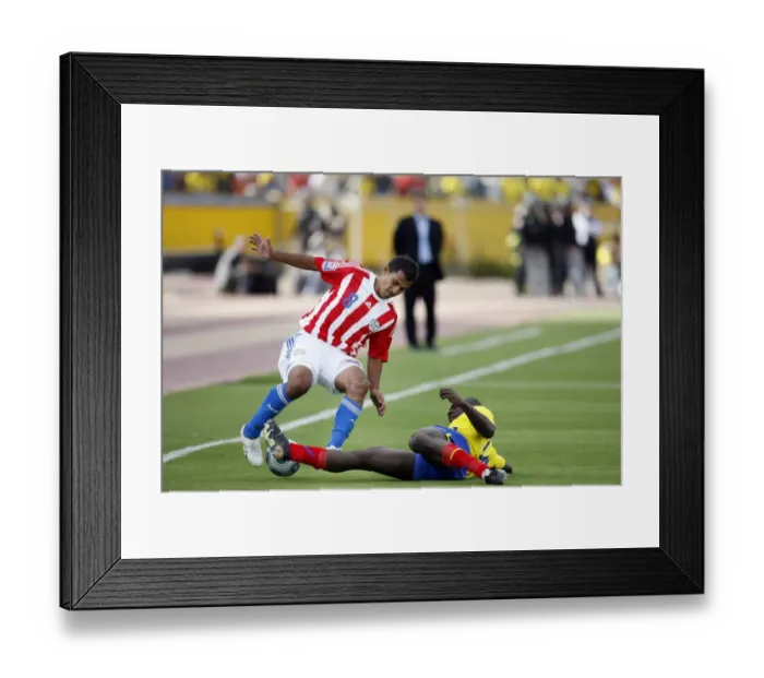 Framed Print : Ecuadors Castillo tackles Paraguays Aquino during their 2010 World Cup qualifying soccer match in Quito