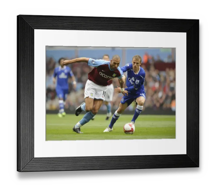Framed Print : Clash at Villa Park: Carew vs Neville - Premier League Battle Framed Print : Clash at Villa Park: Carew vs Neville - Premier League Battle