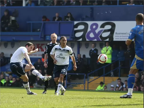 Leighton Baines Scores the Opener: Everton's Triumph at Portsmouth in the Barclays Premier League (2009)