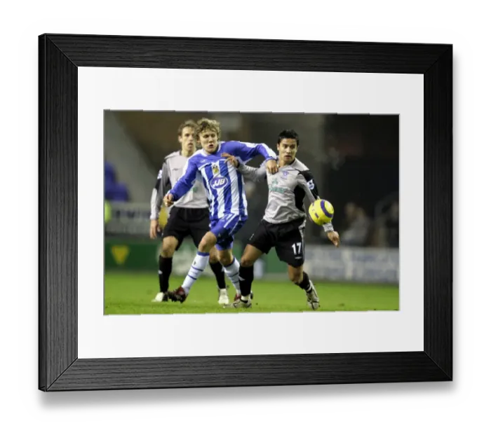 Framed Print : Intense Rivalry: Tim Cahill vs. Jimmy Bullard Clash at Wigan Athletic vs. Everton, FA Barclays Premiership (January 2006) Framed Print : Intense Rivalry: Tim Cahill vs. Jimmy Bullard Clash at Wigan Athletic vs. Everton, FA Barclays Premiership (January 2006)