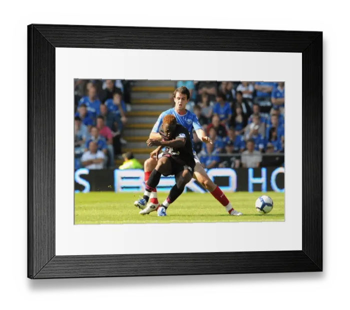Framed Print : Intense Rivalry: Saha vs. Wilson's Battle for Ball in the Premier League Clash at Fratton Park Framed Print : Intense Rivalry: Saha vs. Wilson's Battle for Ball in the Premier League Clash at Fratton Park