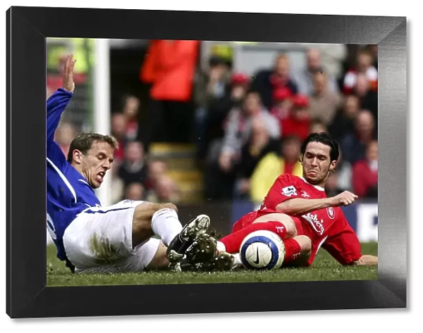 Phil Neville vs Luis Garcia: Intense Tackle on the Football Field