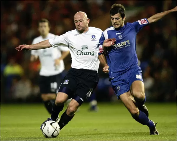Evertons Lee Carsley and Peterbroughs Richard Butcher in action