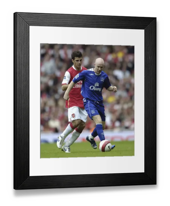 Framed Print : Intense Rivalry: Fabregas vs. Johnson - Arsenal vs. Everton: A Football Battle Framed Print : Intense Rivalry: Fabregas vs. Johnson - Arsenal vs. Everton: A Football Battle