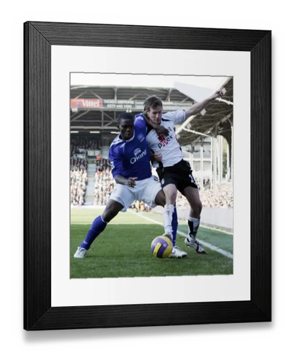 Framed Print : Fulham v Everton - 4  /  11  /  06 Fulhams Brian McBride in action against Evertons Joseph Yobo