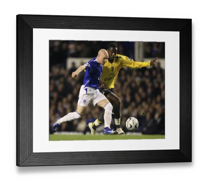 Framed Print : Arsenals Djourou challenges Evertons Johnson for the ball in Liverpool Framed Print : Arsenals Djourou challenges Evertons Johnson for the ball in Liverpool