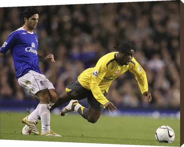 Evertons Arteta challenges Arsenals Song for the ball during their English League Cup fourth round