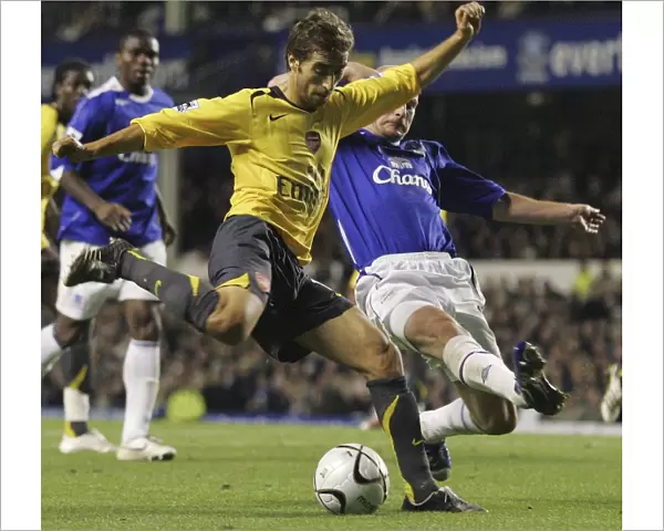 Evertons Carsley challenges Arsenals Flamini for the ball during their English League Cup fourth r