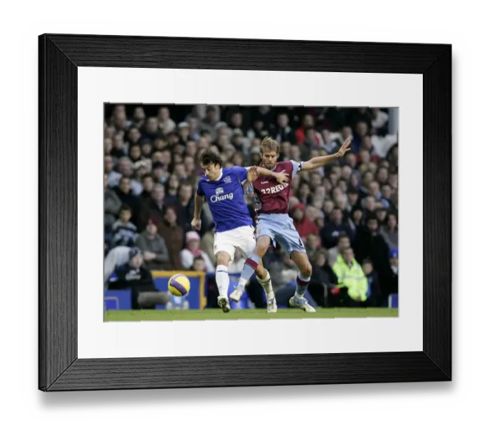 Framed Print : Everton v Aston Villa Evertons Simon Davies in action against Aston Villas Olof Mellberg