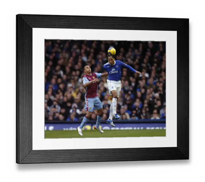 Framed Print : Everton v Aston Villa Joleon Lescott wins a header against Gabriel Agbonlahor