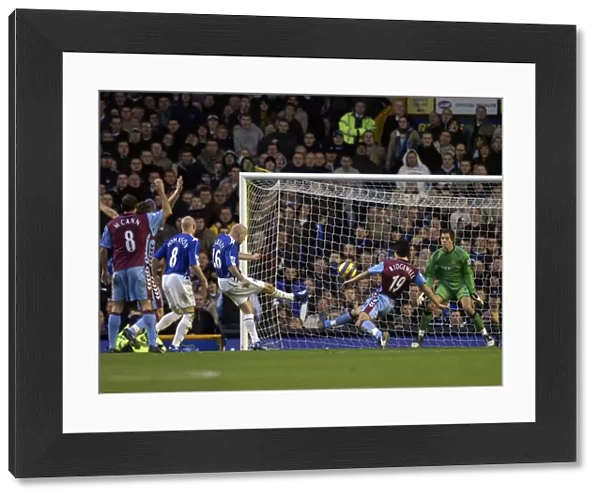 Everton v Aston Villa Lee Carsley - Everton shoots at goal under pressure from Liam Ridgewell