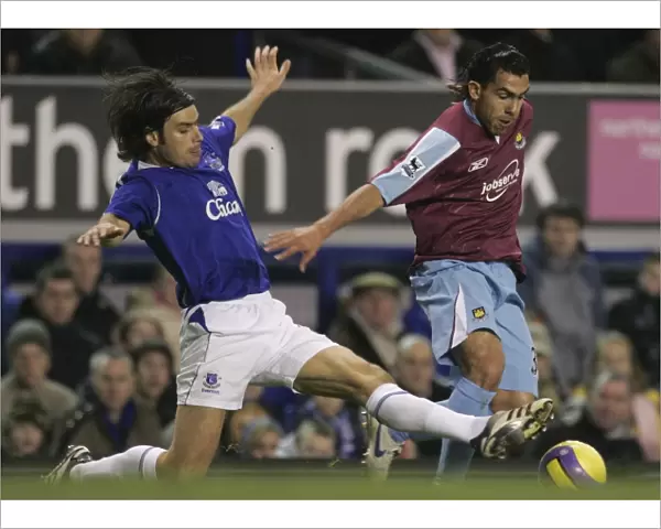 Evertons Valente challenges West Ham Uniteds Tevez for the ball during their English Premier Leagu