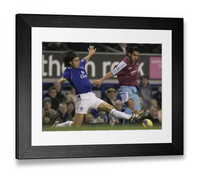Framed Print : Evertons Valente challenges West Ham Uniteds Tevez for the ball during their English Premier Leagu