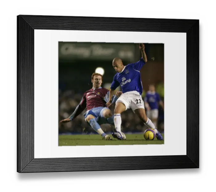 Framed Print : Evertons Vaughan challenges West Ham Uniteds Collins for the ball during their English Premier Lea Framed Print : Evertons Vaughan challenges West Ham Uniteds Collins for the ball during their English Premier Lea
