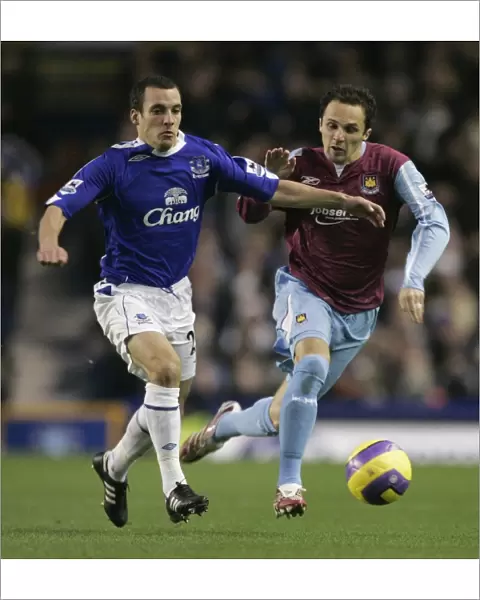 Evertons Osman challenges West Ham Uniteds Etherington for the ball during their English Premier L