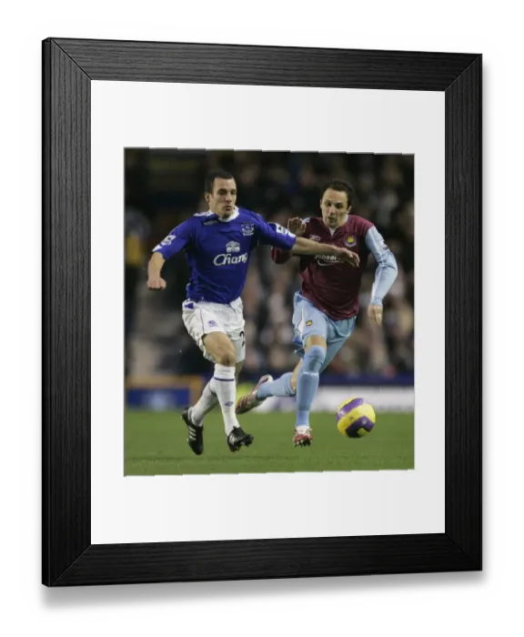 Framed Print : Evertons Osman challenges West Ham Uniteds Etherington for the ball during their English Premier L Framed Print : Evertons Osman challenges West Ham Uniteds Etherington for the ball during their English Premier L