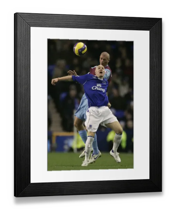 Framed Print : Evertons Johnson challenges West Ham Uniteds Konchesky for the ball during their English Premier L Framed Print : Evertons Johnson challenges West Ham Uniteds Konchesky for the ball during their English Premier L