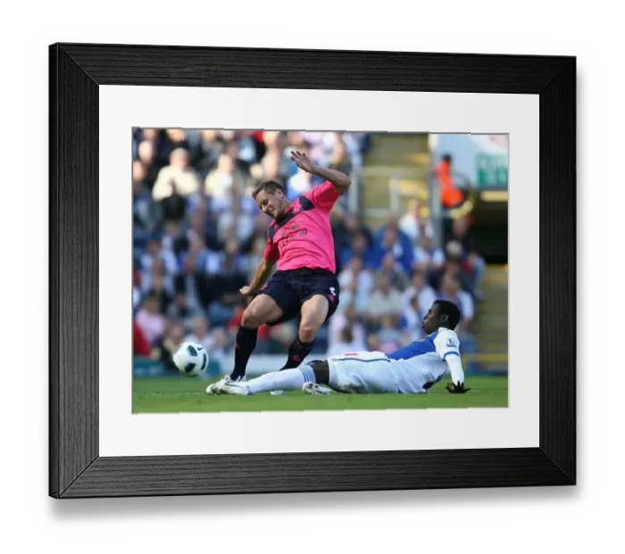 Framed Print : Intense Tackle: Mame Diouf vs. Phil Jagielka - Barclays Premier League Showdown (August 14, 2010, Ewood Park) Framed Print : Intense Tackle: Mame Diouf vs. Phil Jagielka - Barclays Premier League Showdown (August 14, 2010, Ewood Park)