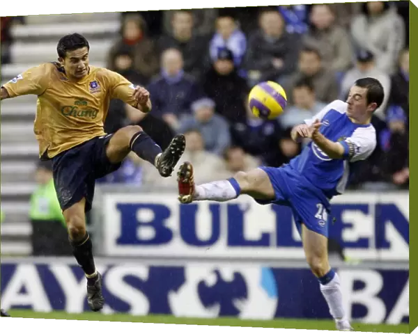 Wigan Athletics Baines challenges Evertons Cahill for the ball during their English Premier League