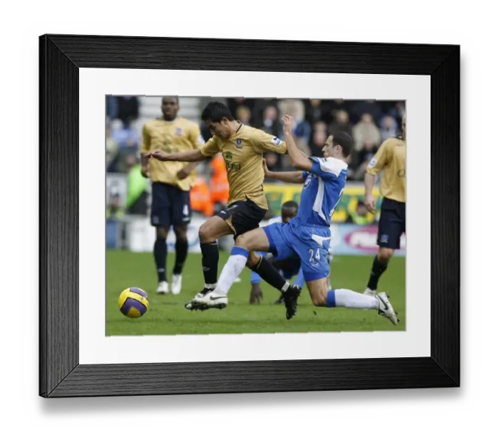 Framed Print : Wigan Athletics Skoko challenges Evertons Cahill for the ball during their English Premier League Framed Print : Wigan Athletics Skoko challenges Evertons Cahill for the ball during their English Premier League