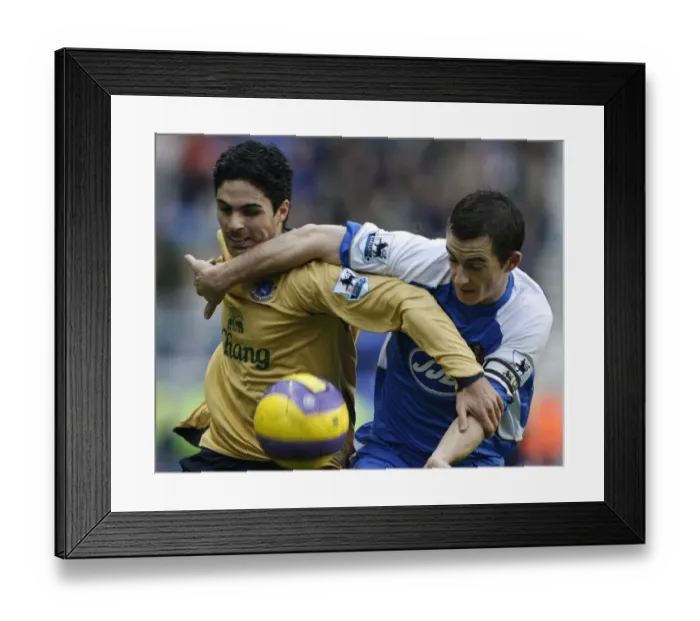 Framed Print : Wigan Athletics Baines challenges Evertons Arteta for the ball during their English Premier League Framed Print : Wigan Athletics Baines challenges Evertons Arteta for the ball during their English Premier League