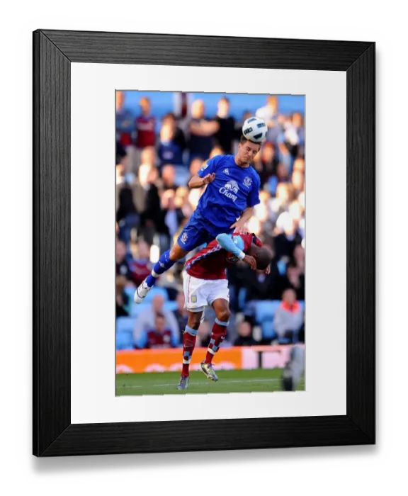 Framed Print : Jagielka's Dominance: Everton's Phil Jagielka Outmuscles Young in Aston Villa vs Everton (Barclays Premier League, 29 August 2010, Villa Park) Framed Print : Jagielka's Dominance: Everton's Phil Jagielka Outmuscles Young in Aston Villa vs Everton (Barclays Premier League, 29 August 2010, Villa Park)