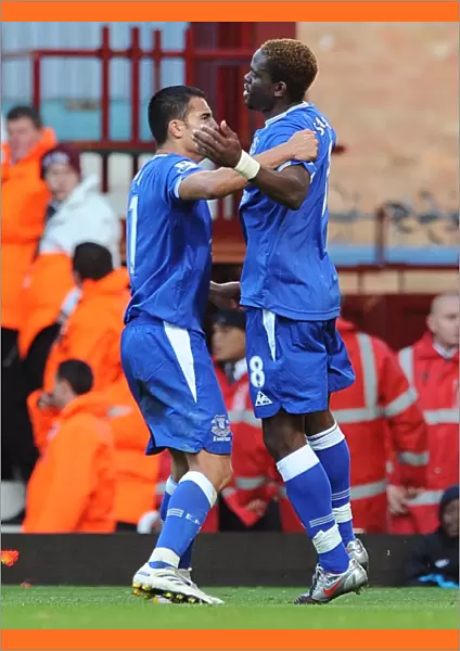 Everton's Saha and Cahill: A Powerful Duo Celebrates the Opening Goal Against West Ham in the Premier League