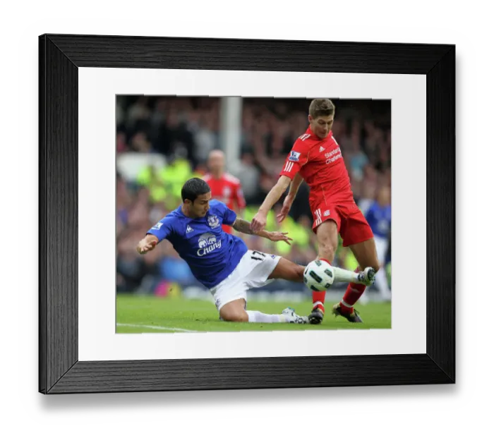 Framed Print : Intense Rivalry: Tim Cahill vs Steven Gerrard Battle for the Ball at Goodison Park Framed Print : Intense Rivalry: Tim Cahill vs Steven Gerrard Battle for the Ball at Goodison Park