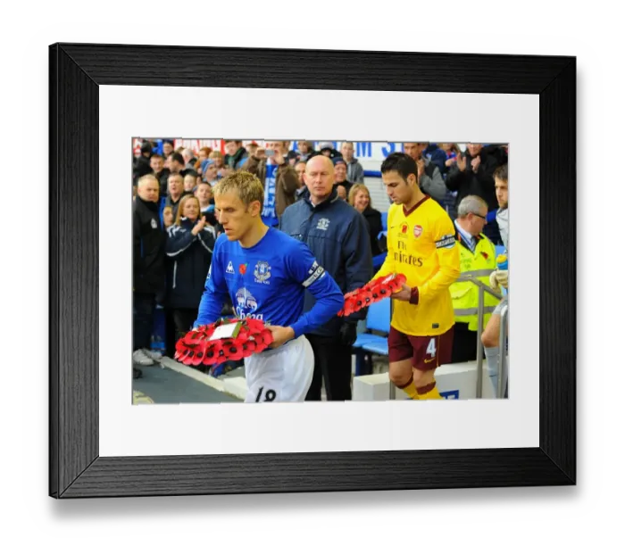 Framed Print : Phil Neville and Cesc Fabregas Lead Out Poppy Wreaths: Everton vs. Arsenal in the Barclays Premier League (November 14, 2010)
