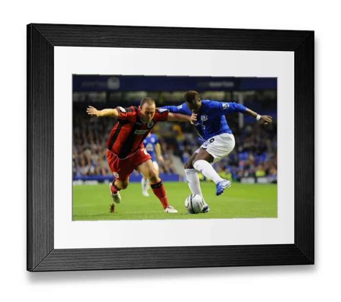Framed Print : Intense Rivalry on the Football Field: Magaye Gueye vs. Lee Croft