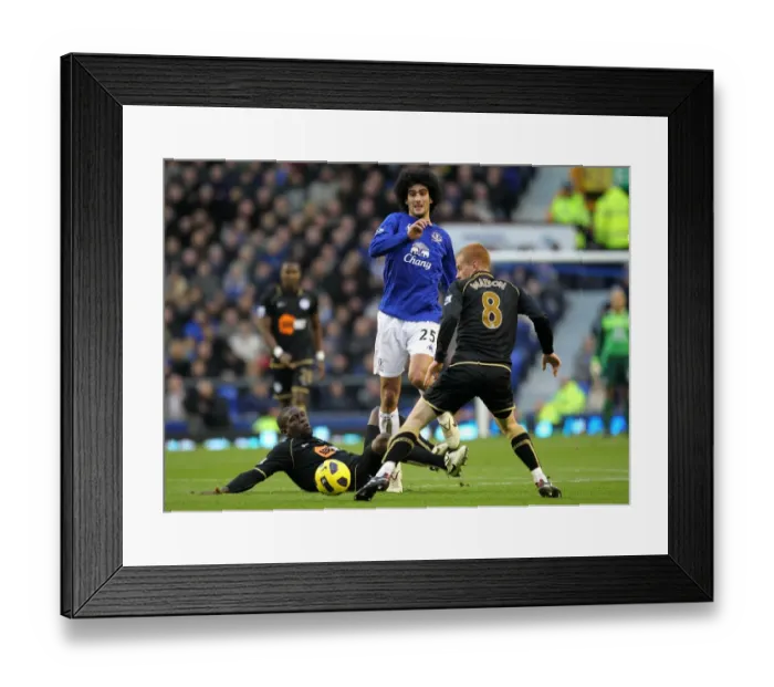 Framed Print : Marouane Fellaini in Action: Everton vs. Wigan Athletic (11 December 2010, Goodison Park) - A Battle Against Hendry Thomas and Ben Watson
