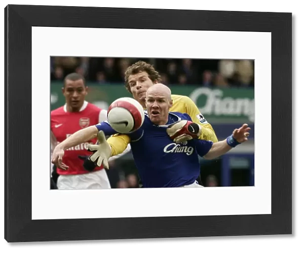 Evertons Johnson challenges Arsenals Lehmann for the ball during their English Premier League socc
