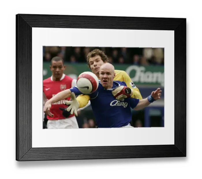 Framed Print : Evertons Johnson challenges Arsenals Lehmann for the ball during their English Premier League socc