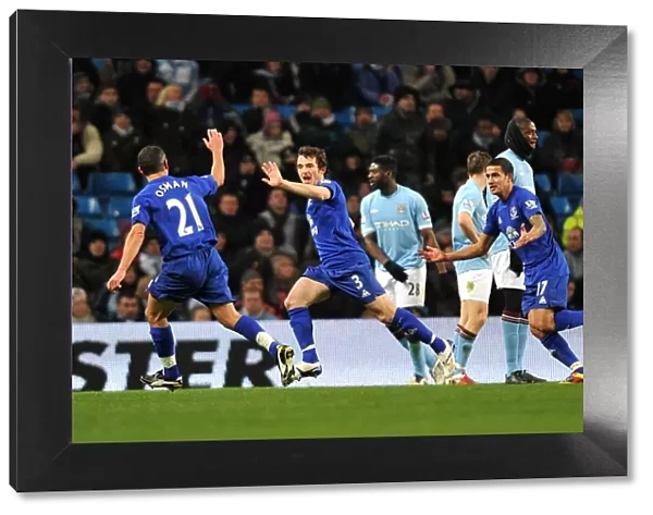 Everton's Triumphant Trio: Tim Cahill, Leon Osman, and Leighton Baines Celebrate Second Goal vs. Manchester City (2010)