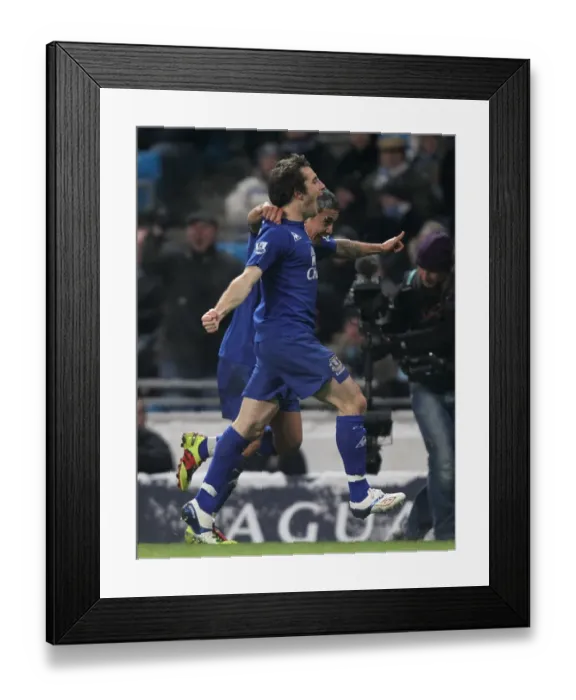 Framed Print : Everton's Unforgettable Double Strike: Tim Cahill and Leighton Baines Celebrate Against Manchester City (December 2010)