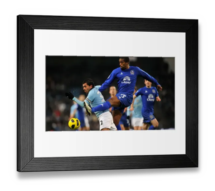 Framed Print : Manchester Derby Showdown: Distin vs Tevez - A Battle for Premier League Supremacy (December 2010) Framed Print : Manchester Derby Showdown: Distin vs Tevez - A Battle for Premier League Supremacy (December 2010)