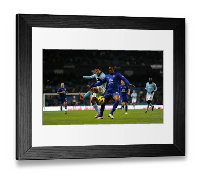 Framed Print : Battle for the Ball: Distin vs Tevez - A Premier League Rivalry (Manchester City vs Everton, 20 December 2010)