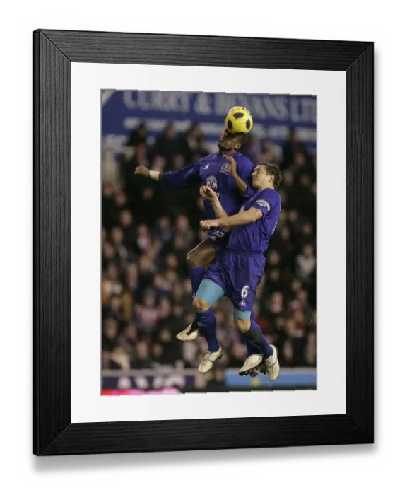 Framed Print : Intense Rivalry: Distin vs Jagielka's Battle for the Ball - Everton vs Stoke City, Barclays Premier League (01.01.2011) Framed Print : Intense Rivalry: Distin vs Jagielka's Battle for the Ball - Everton vs Stoke City, Barclays Premier League (01.01.2011)