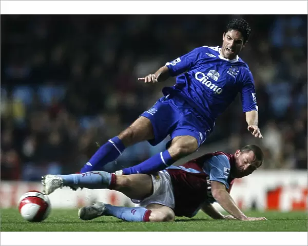 Aston Villas Bardsley challenges Evertons Arteta for the ball during their English Premier League