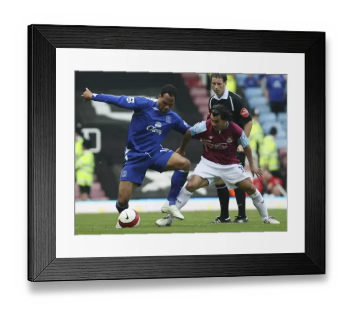 Framed Print : West Ham United v Everton Carlos Tevez with Joleon Lescott