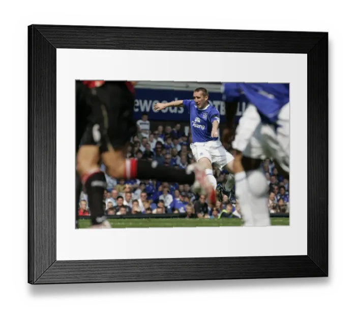 Framed Print : Evertons Stubbs shoots to score during their English Premier League soccer match against Manchester Framed Print : Evertons Stubbs shoots to score during their English Premier League soccer match against Manchester