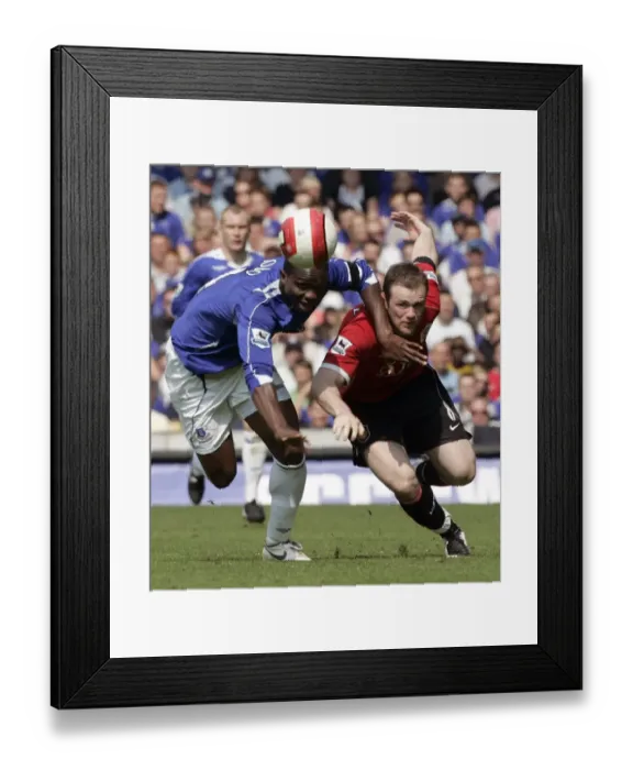 Framed Print : Evertons Yobo challenges Manchester Uniteds Rooney for the ball during their English Premier Leagu Framed Print : Evertons Yobo challenges Manchester Uniteds Rooney for the ball during their English Premier Leagu