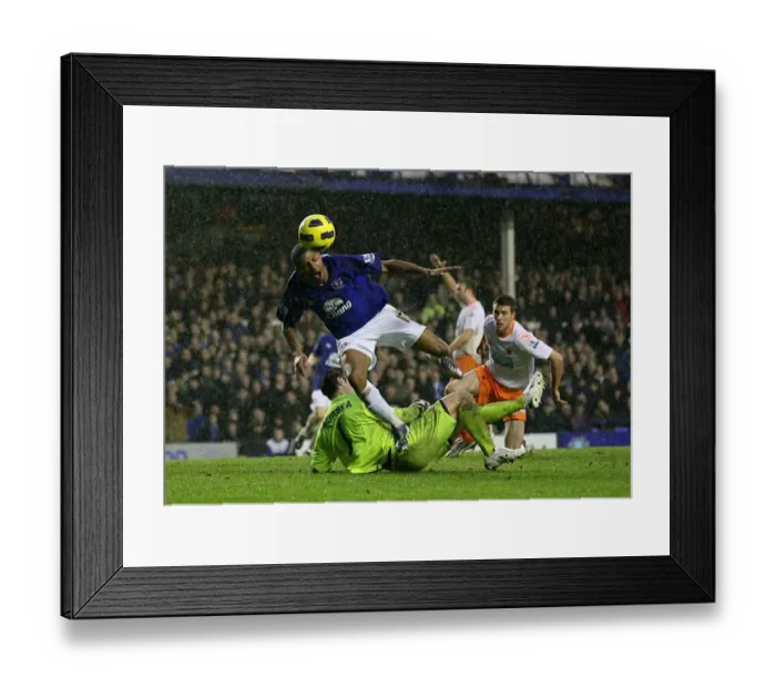 Framed Print : Everton's Jermaine Beckford Tumbles After Collision with Blackpool's Paul Rachubka (05 February 2011) Framed Print : Everton's Jermaine Beckford Tumbles After Collision with Blackpool's Paul Rachubka (05 February 2011)